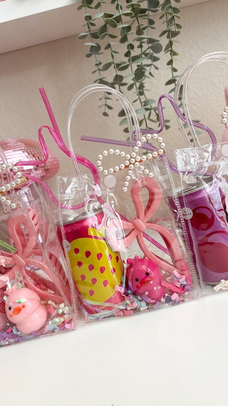 Clear plastic gift bags filled with colorful confetti and pink party favors.