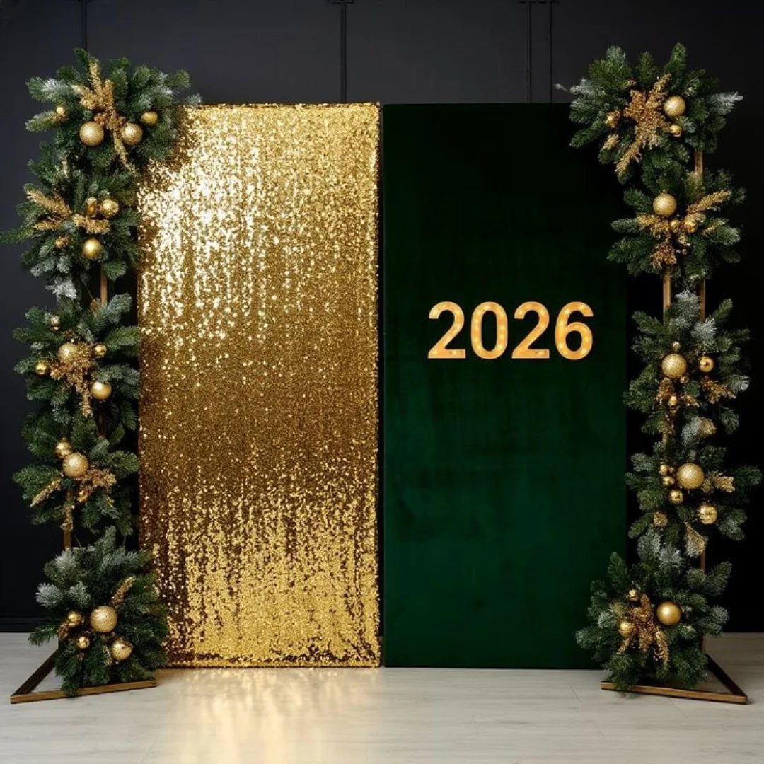 Gold sequin and green velvet backdrop with 2026 numbers and evergreen garlands.