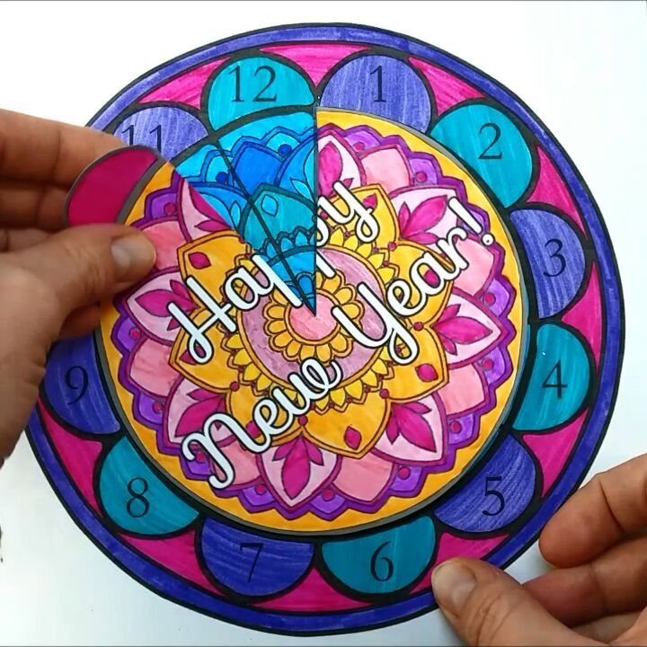 Colorful paper craft New Year's clock with a mandala design and numbers.
