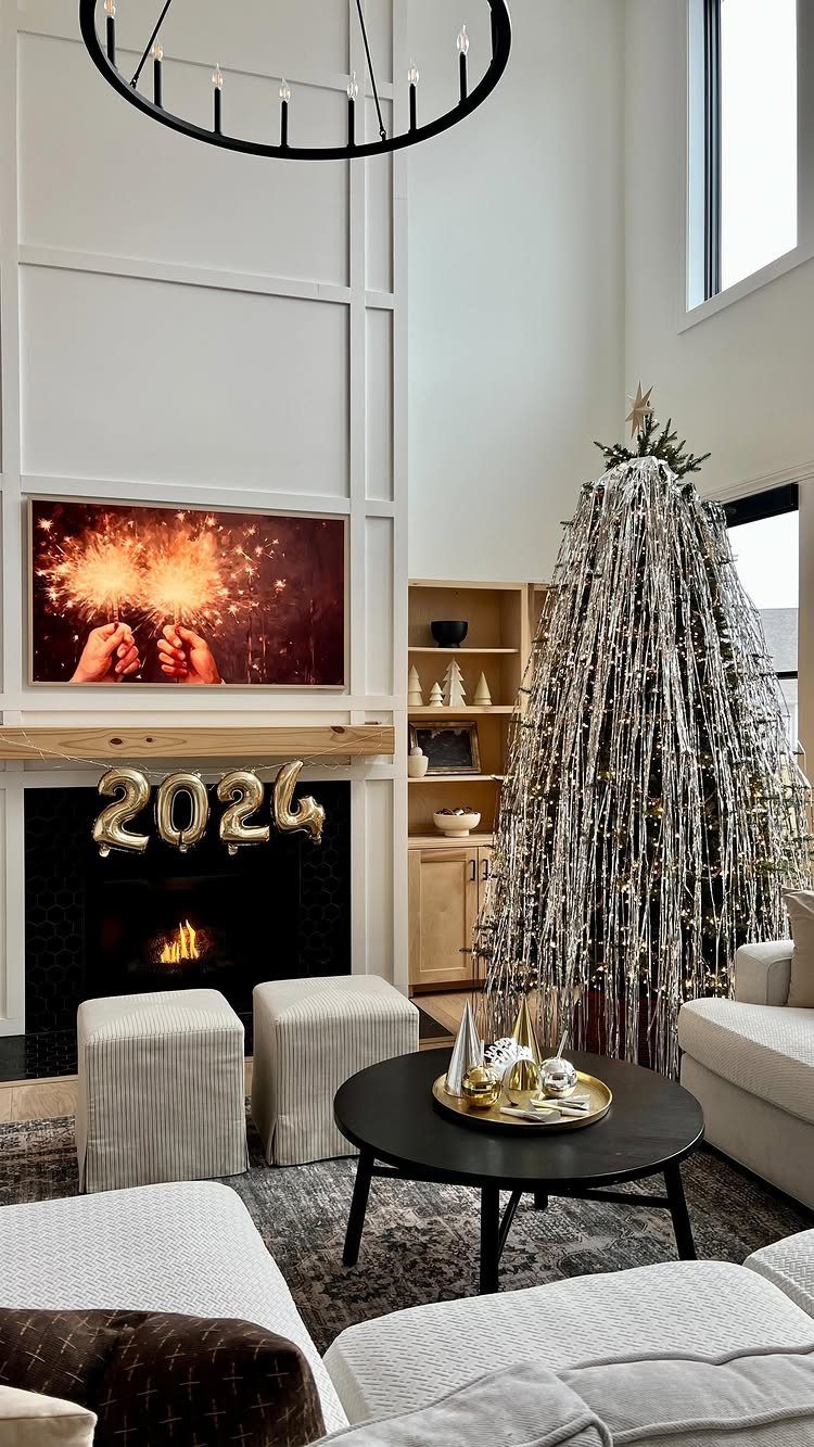 Living room decorated for New Year's with 2024 balloons and silver tinsel tree