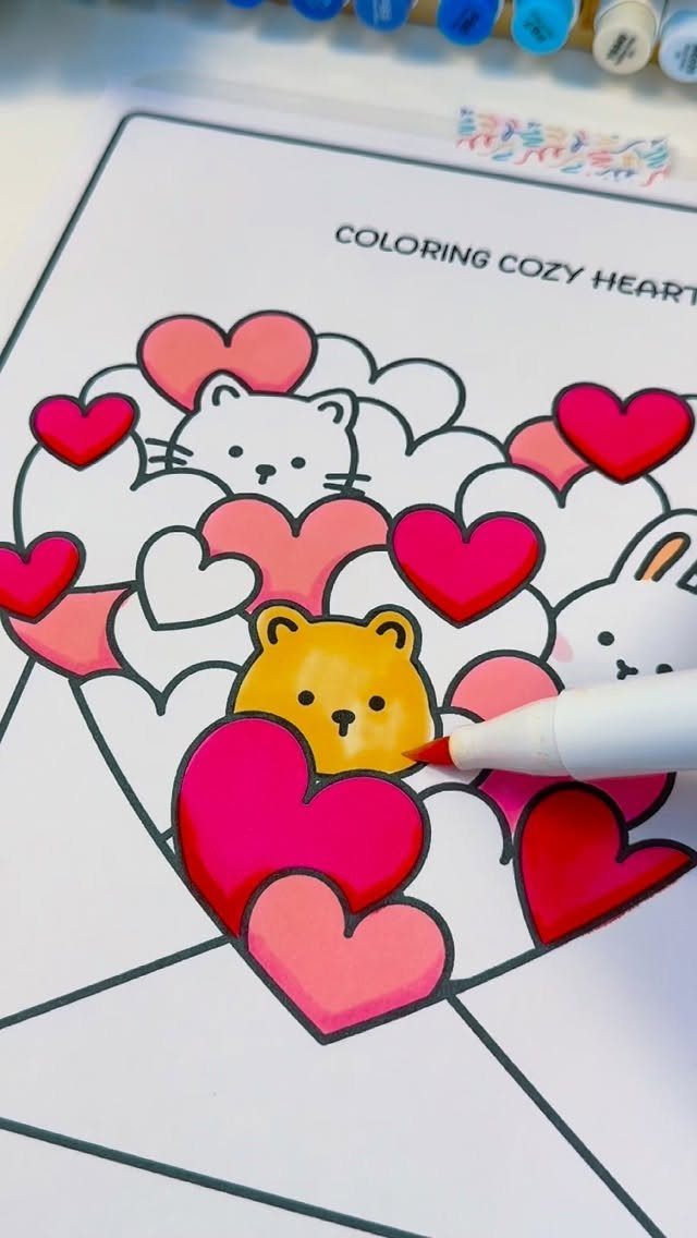 Hand coloring a cute bear and hearts on a Valentine's Day coloring page.