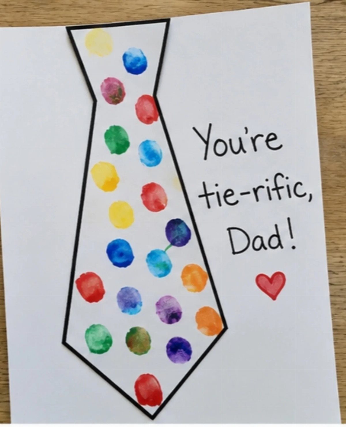 Handmade Father's Day card with a fingerprint paint tie and tie-rific pun text.