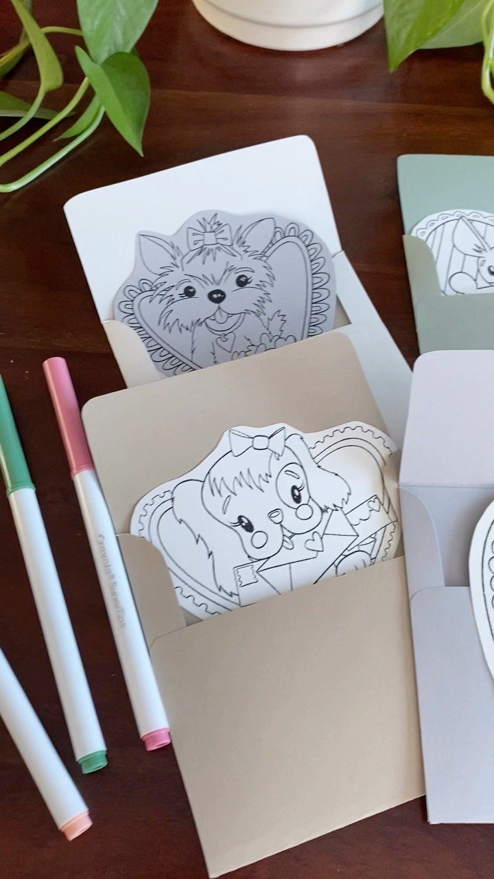 Line art animal coloring pages tucked into envelopes with colorful markers nearby.