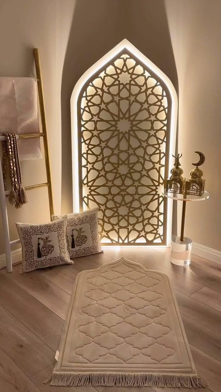 Prayer rug and cushions in front of a backlit geometric arched wall panel.