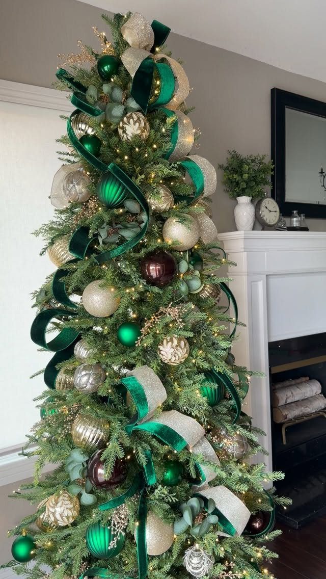 Decorated Christmas tree with green and gold ribbons and colorful ornaments.