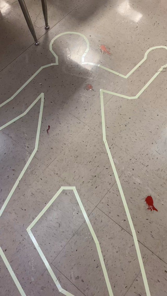 White chalk body outline on a tiled floor with red blood splatters.