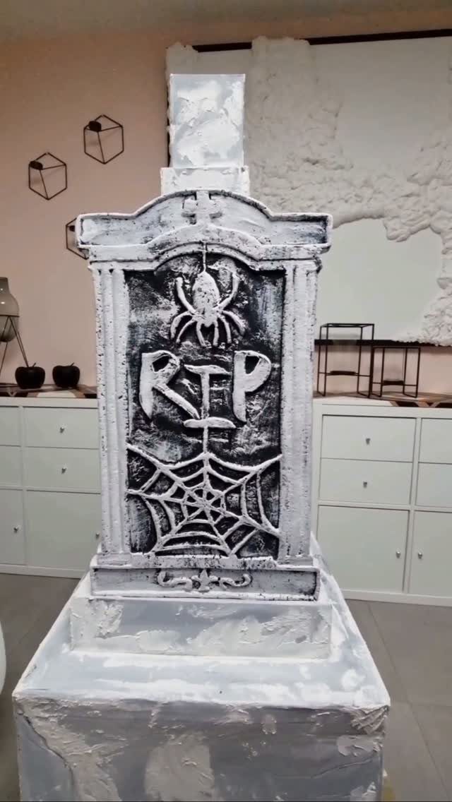 Handmade grey tombstone decoration with a spider and RIP text for Halloween.