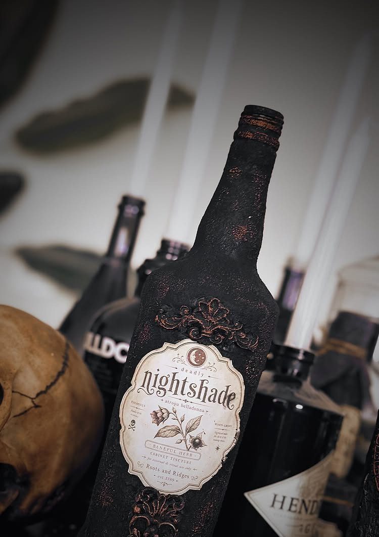Dark textured potion bottles with vintage labels and a weathered human skull.