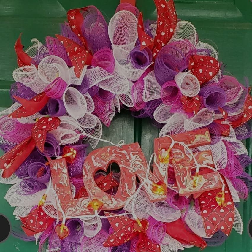 Valentine's Day wreath with pink and purple mesh and a LOVE sign.