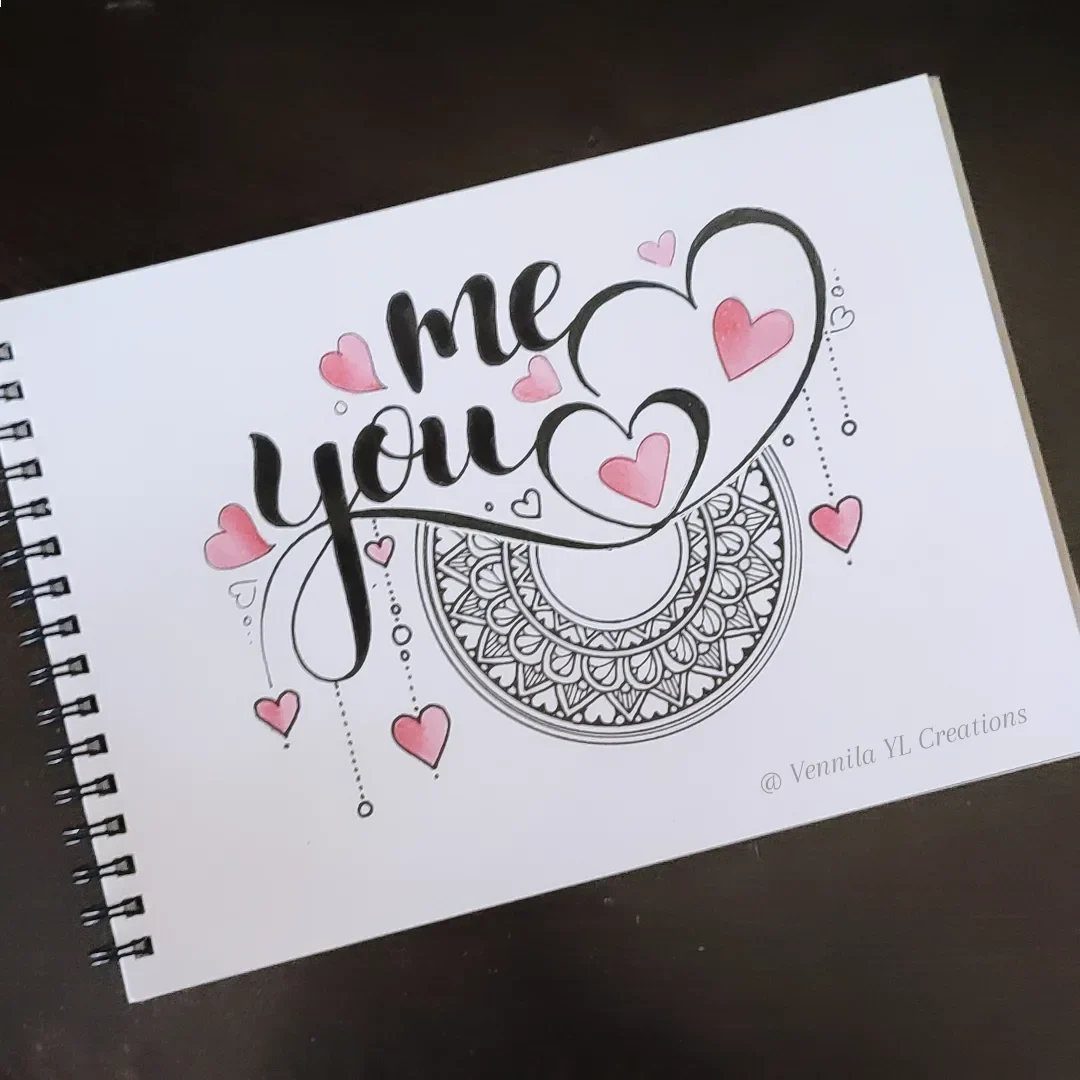 Calligraphy drawing of me you with pink hearts and a mandala on paper