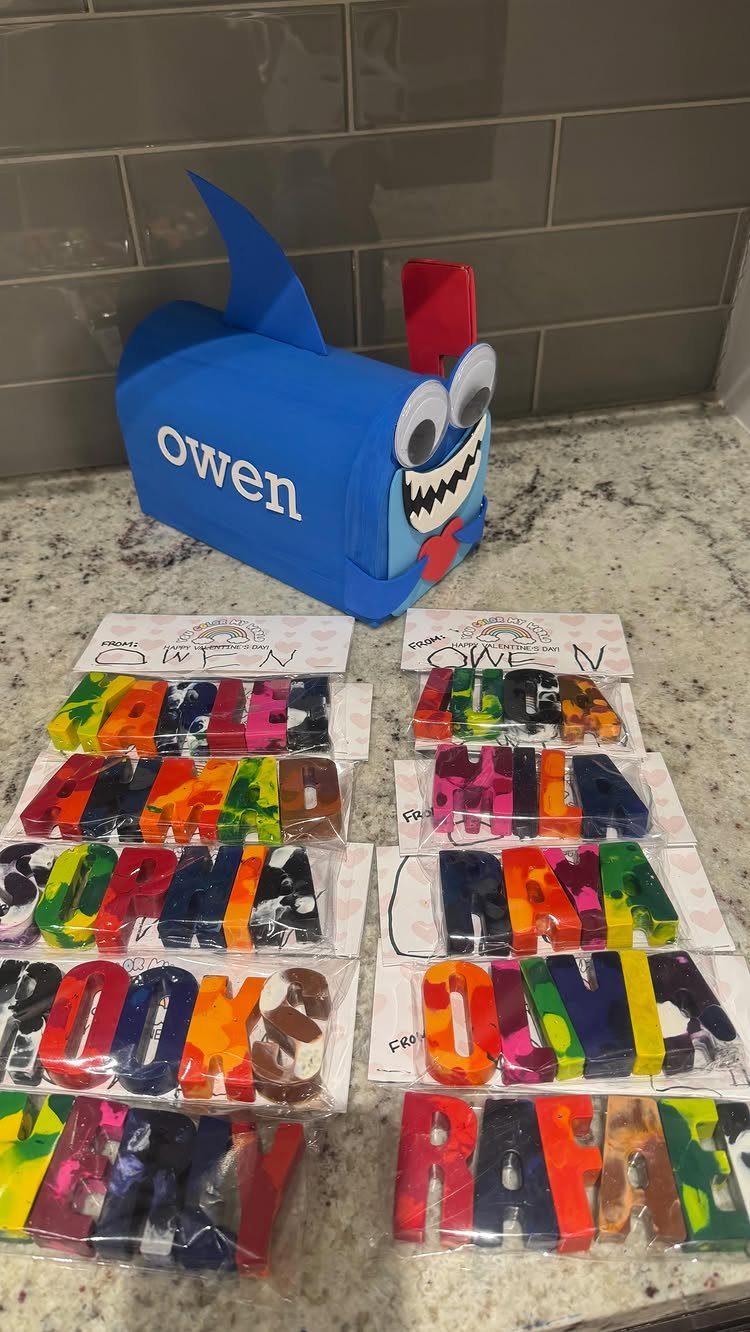 Blue shark mailbox and colorful melted crayons shaped into children's names on cards.