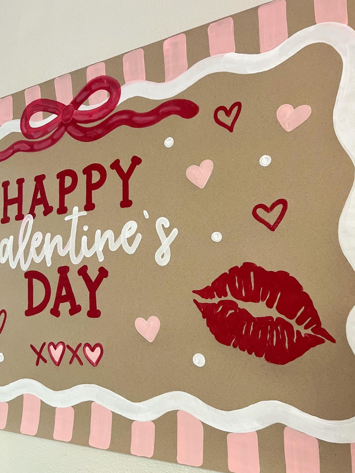 Brown Valentine's Day banner with red text, pink hearts, and red lip print.