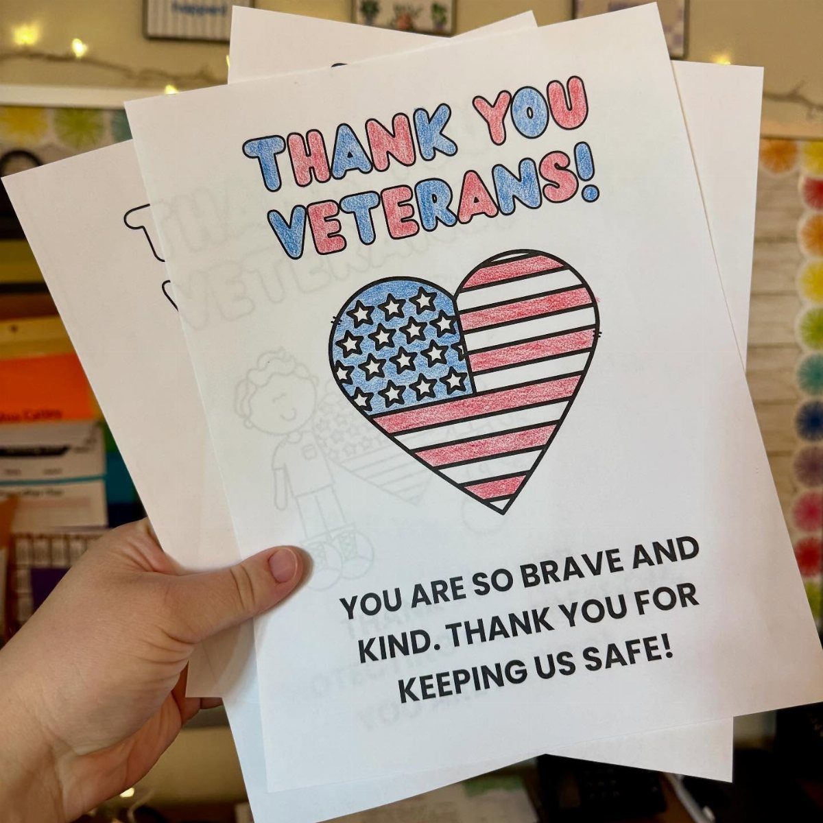 Colored Veterans Day coloring page with a flag heart and thank you message.