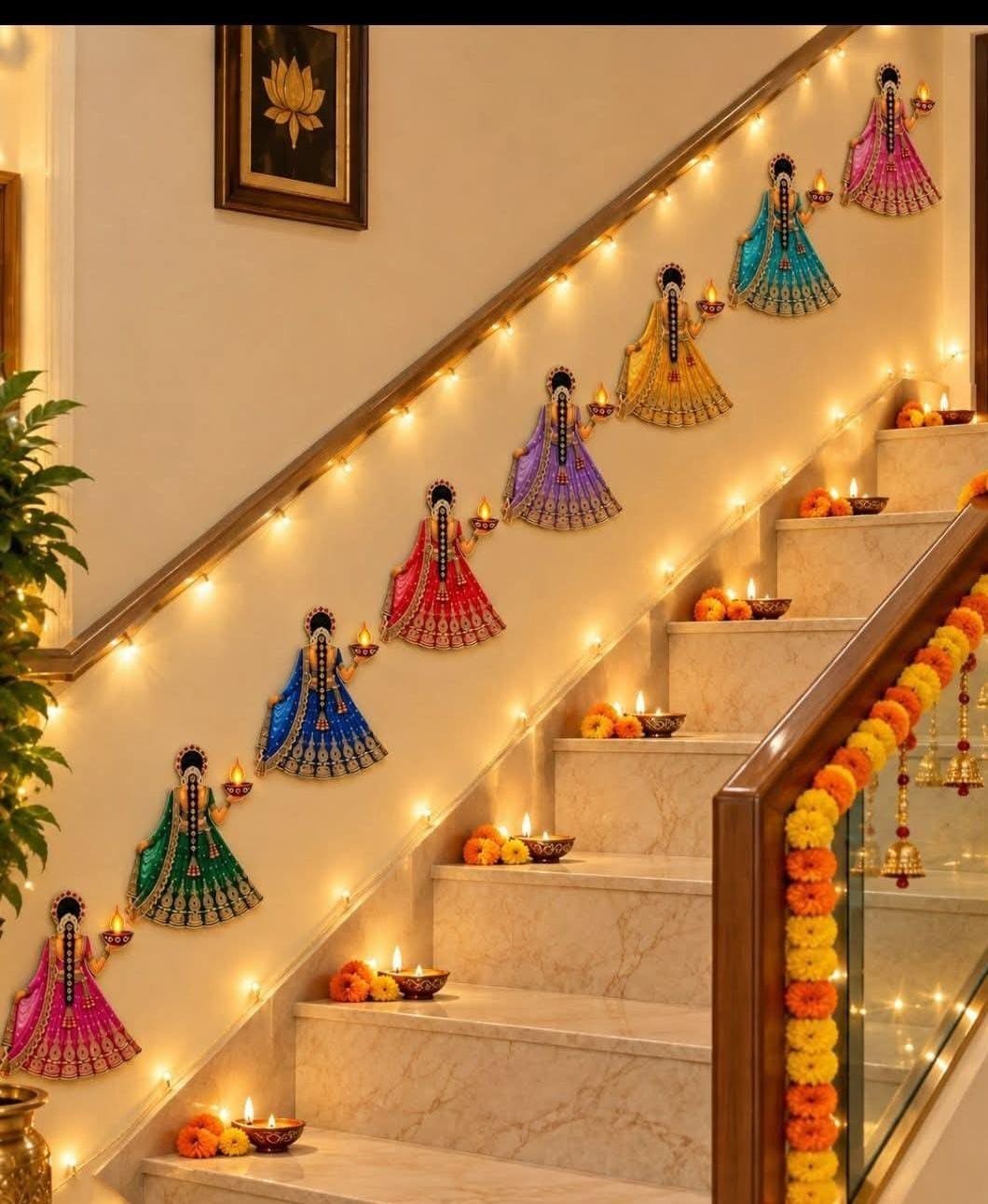 Colorful female figure wall decals and oil lamps decorating a white staircase for Diwali.