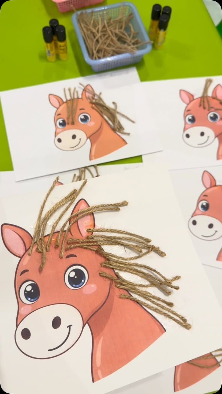 Cartoon horse drawings with brown twine glued on as manes for a craft project